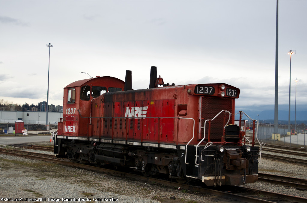 Roster shot of NREX 1237, idling on a side track in Brownsville.